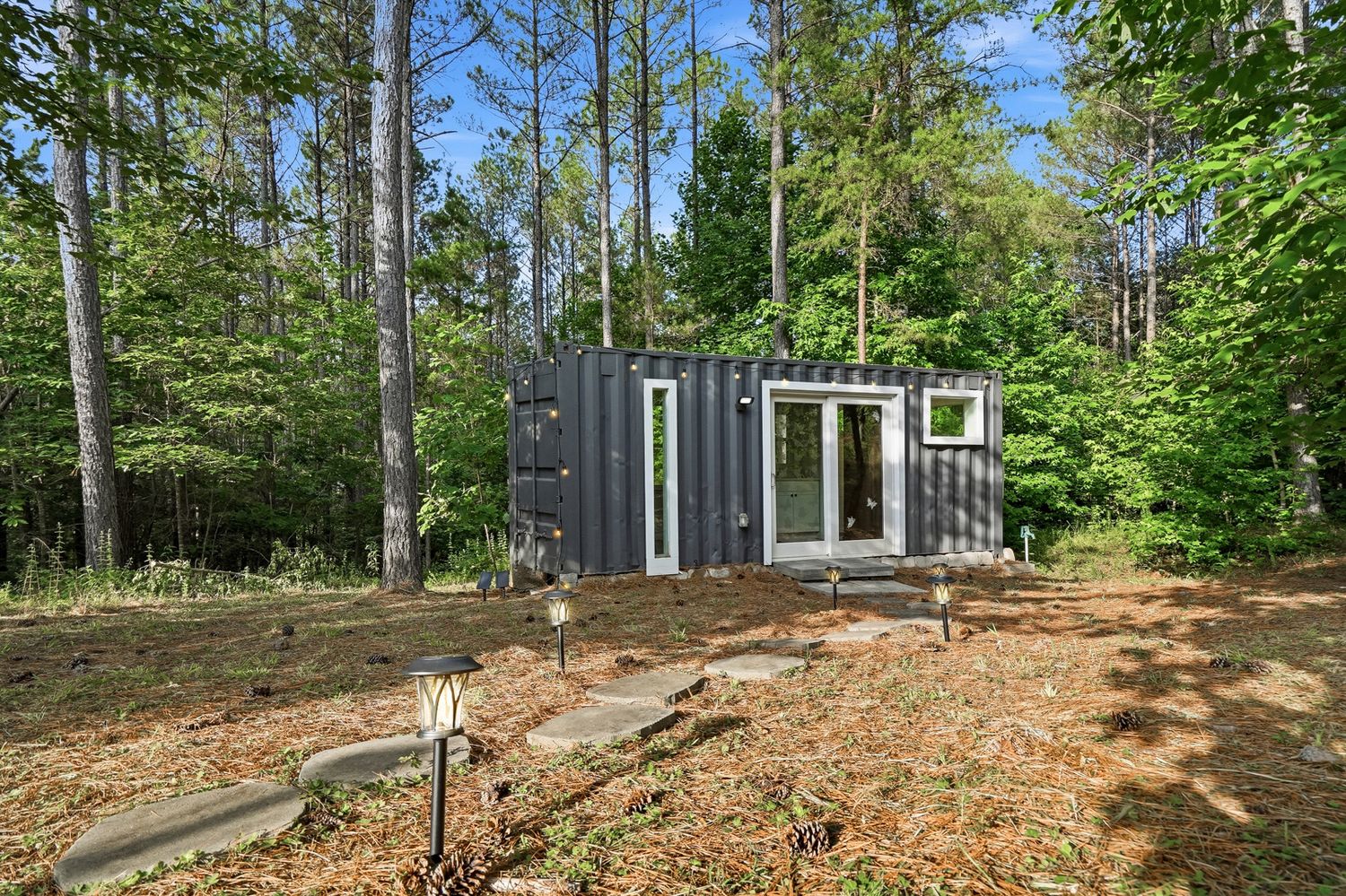The container she-shed tucked among the pines